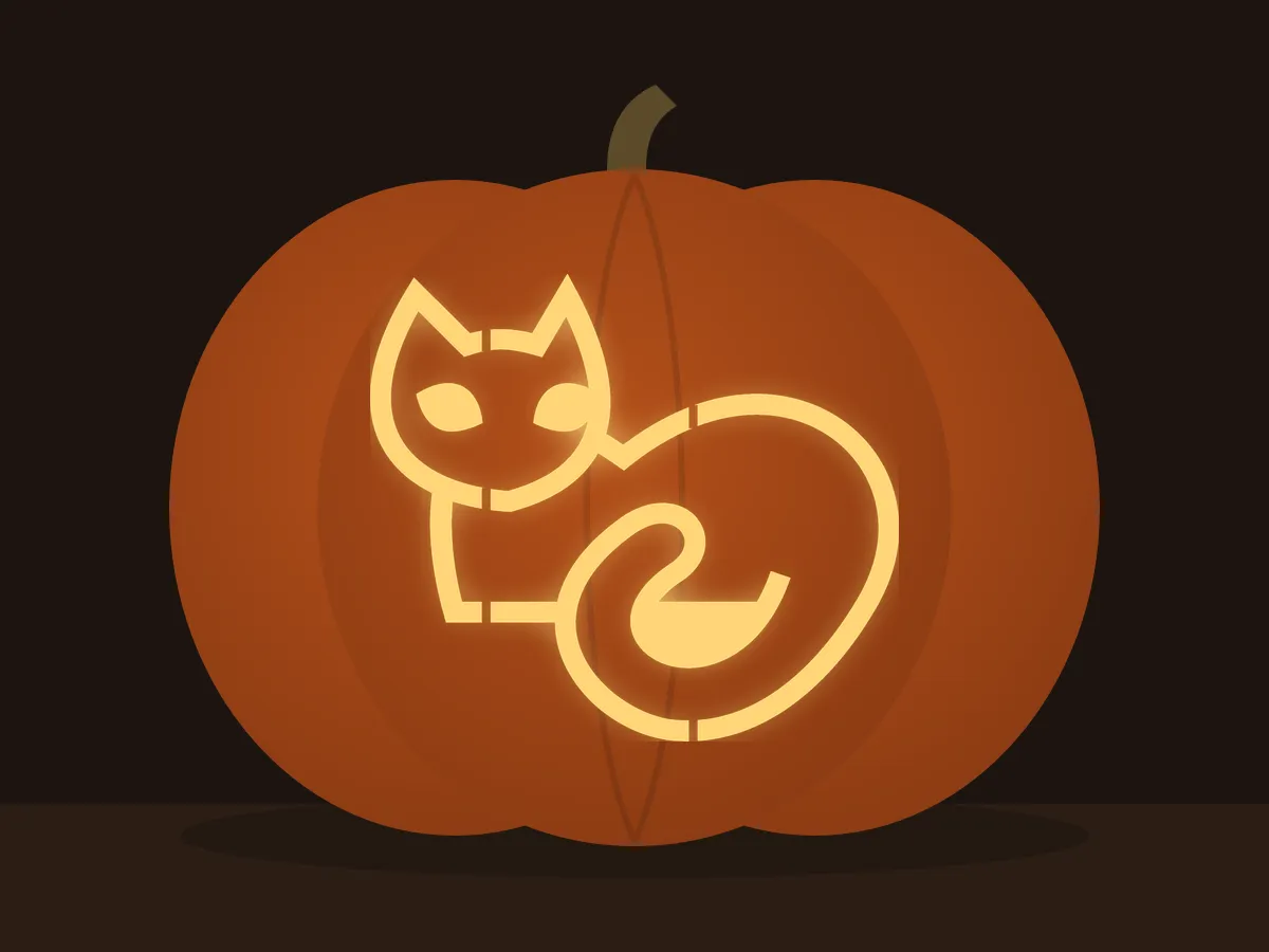 Carved pumpkin with the black cat pattern, lit by a candle