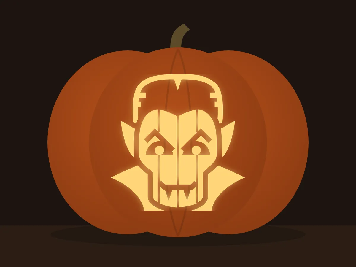 Carved pumpkin with the dracula pattern, lit by a candle