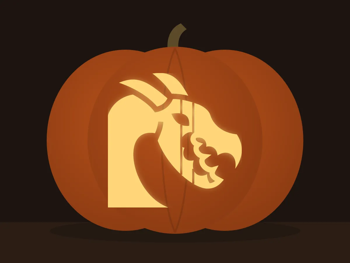 Carved pumpkin with the dragon head pattern, lit by a candle