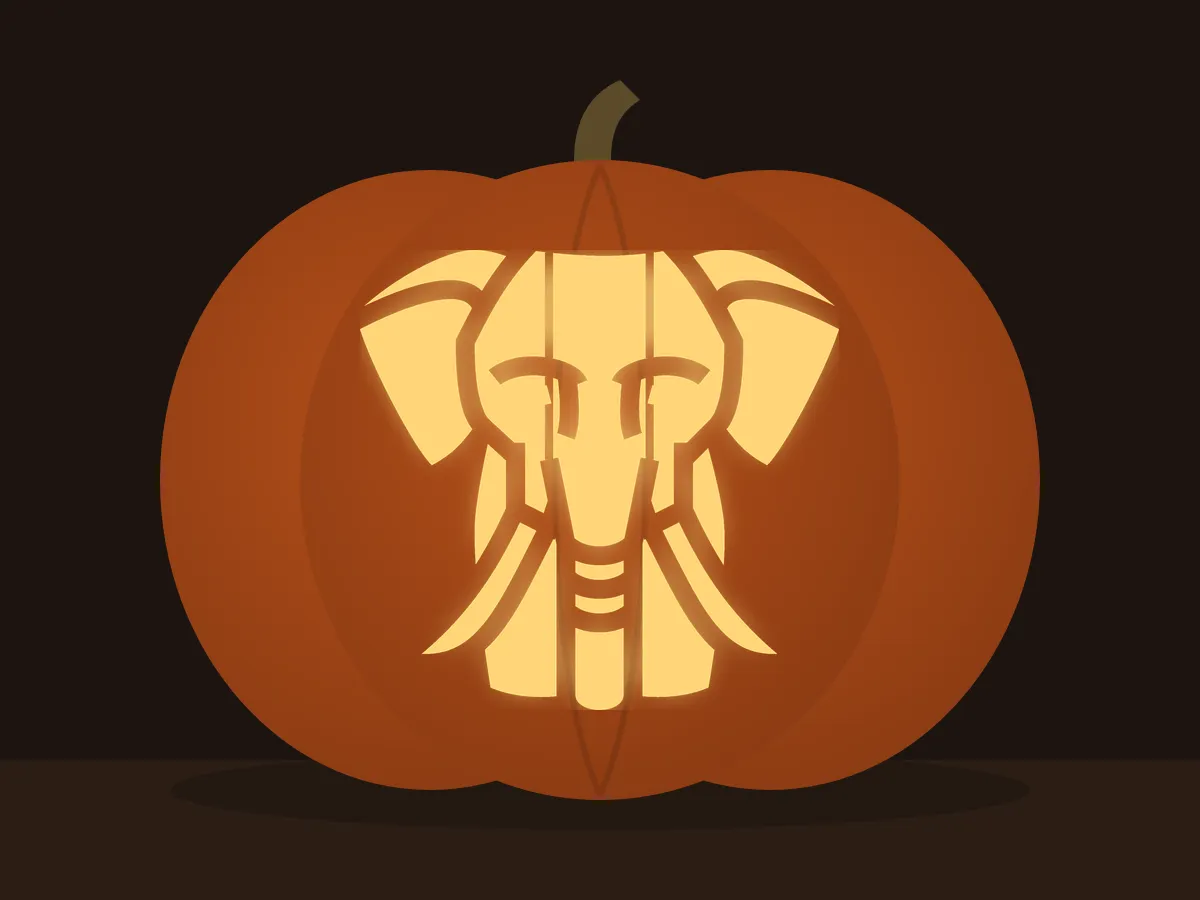 Carved pumpkin with the elephant pattern, lit by a candle