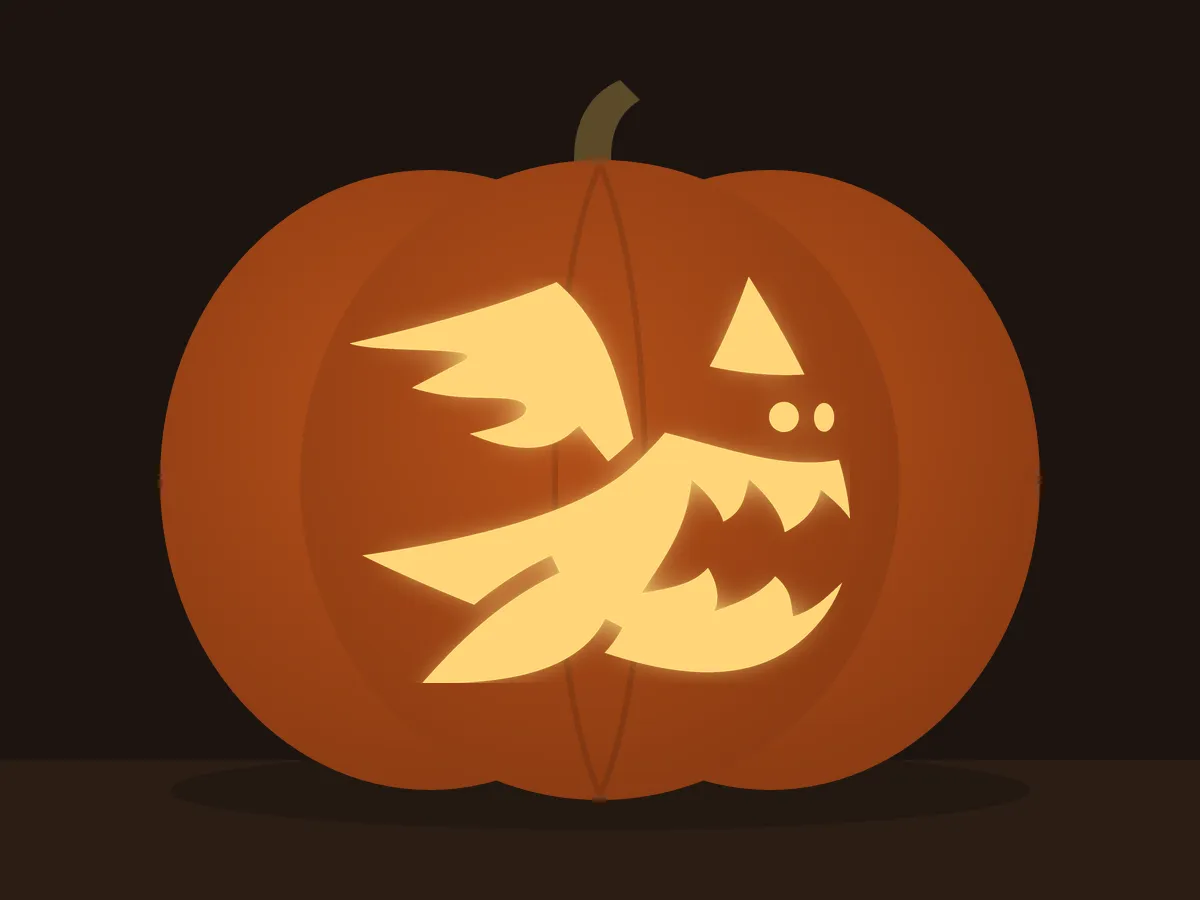 Carved pumpkin with the floating ghost pattern, lit by a candle