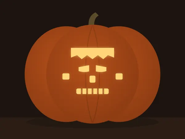 Carved pumpkin with the frankenstein face pattern, lit by a candle