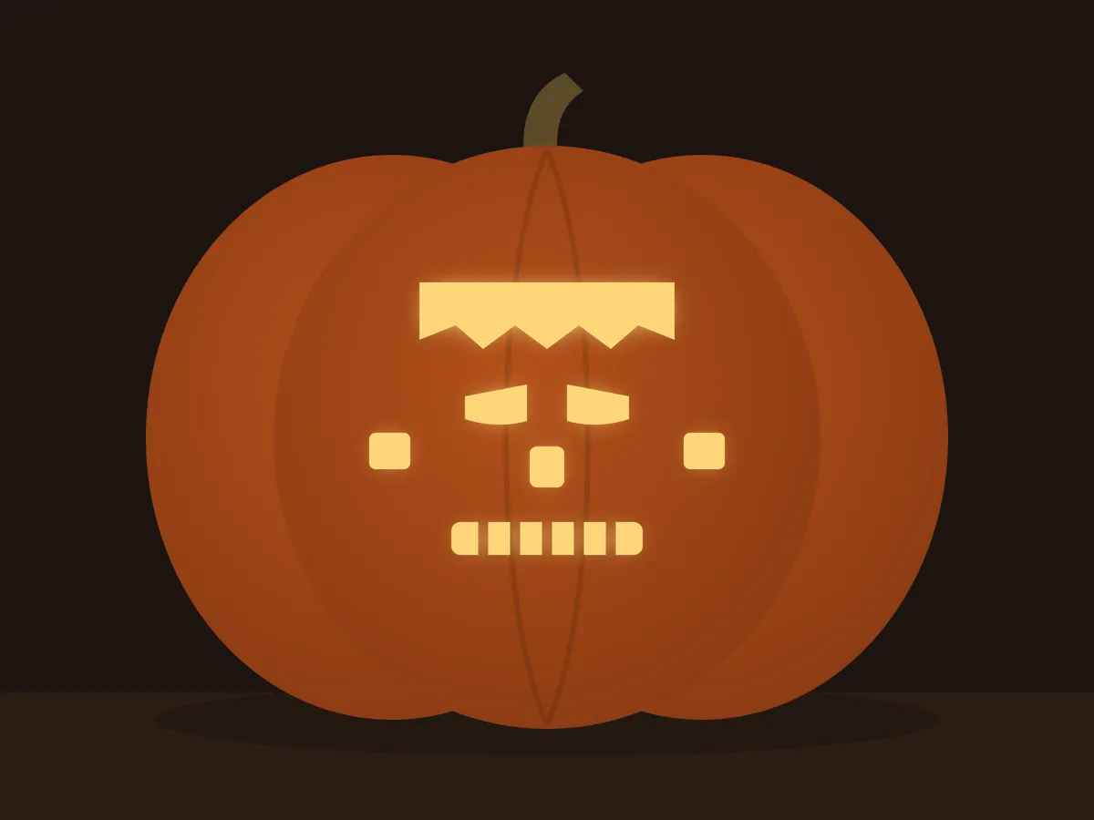 Carved pumpkin with the frankenstein face pattern, lit by a candle
