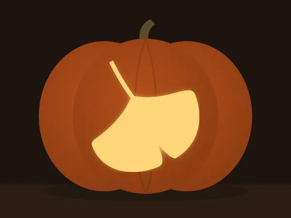 Carved pumpkin with the ginkgo leaf pattern, lit by a candle