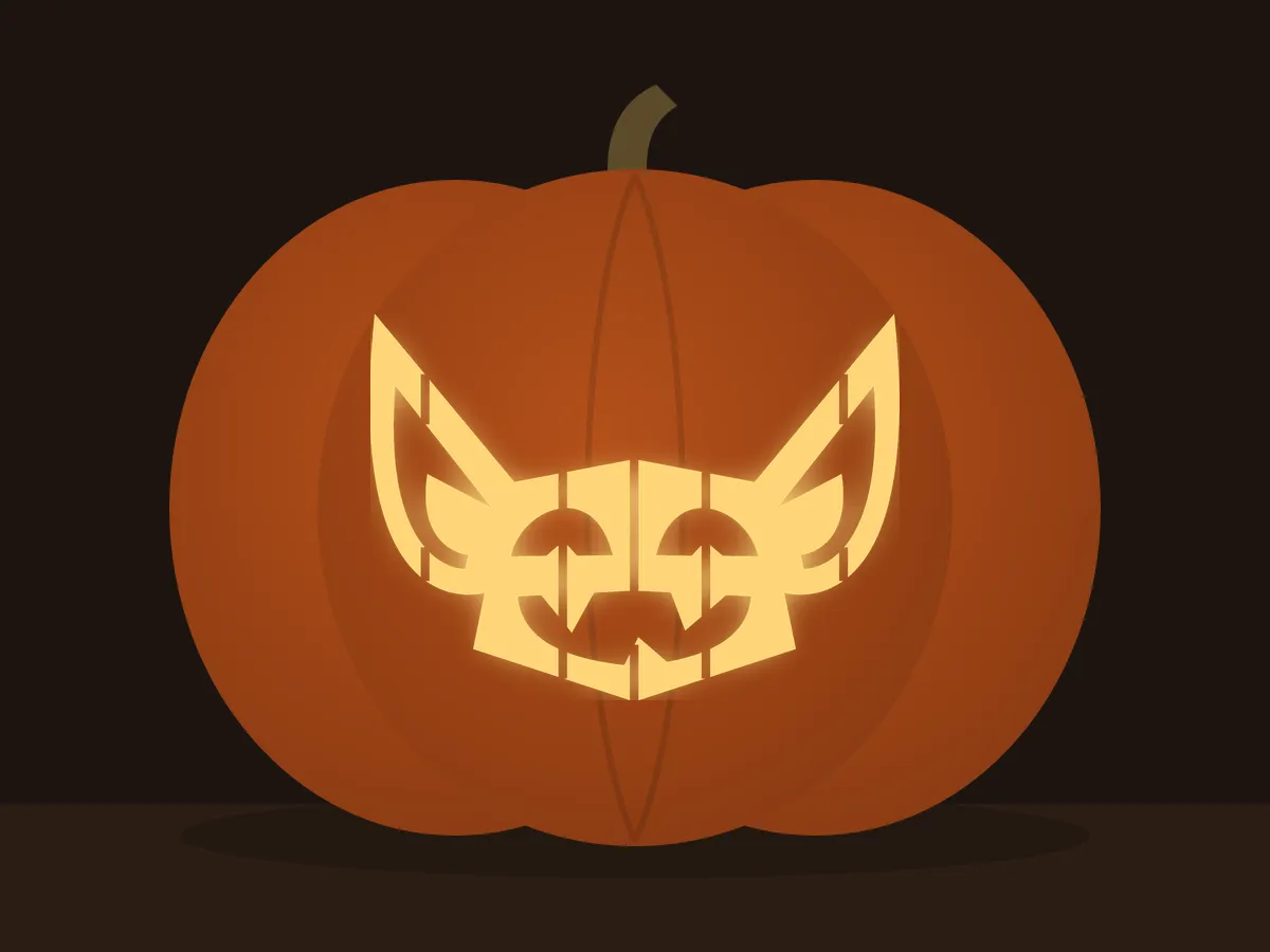 Carved pumpkin with the goblin pattern, lit by a candle