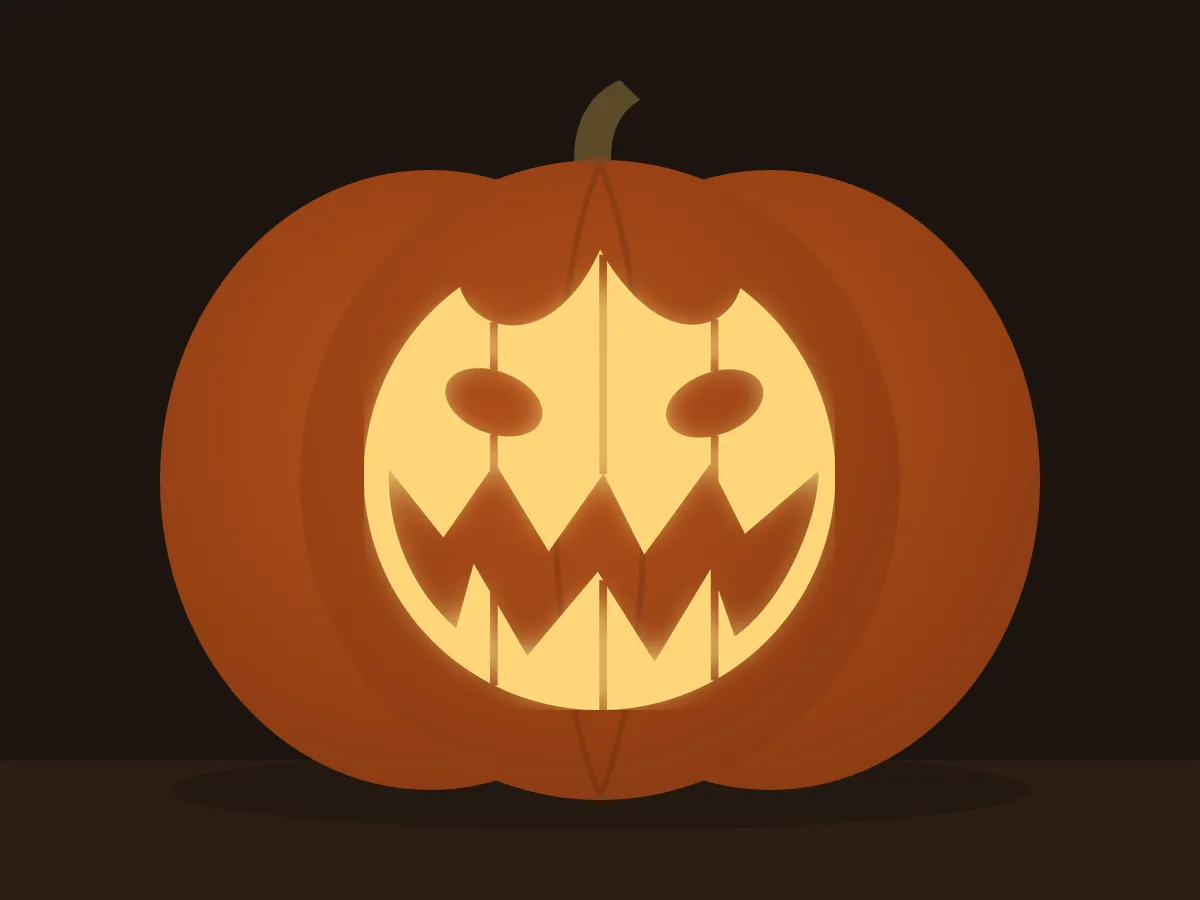 Carved pumpkin with the grinning pumpkin pattern, lit by a candle