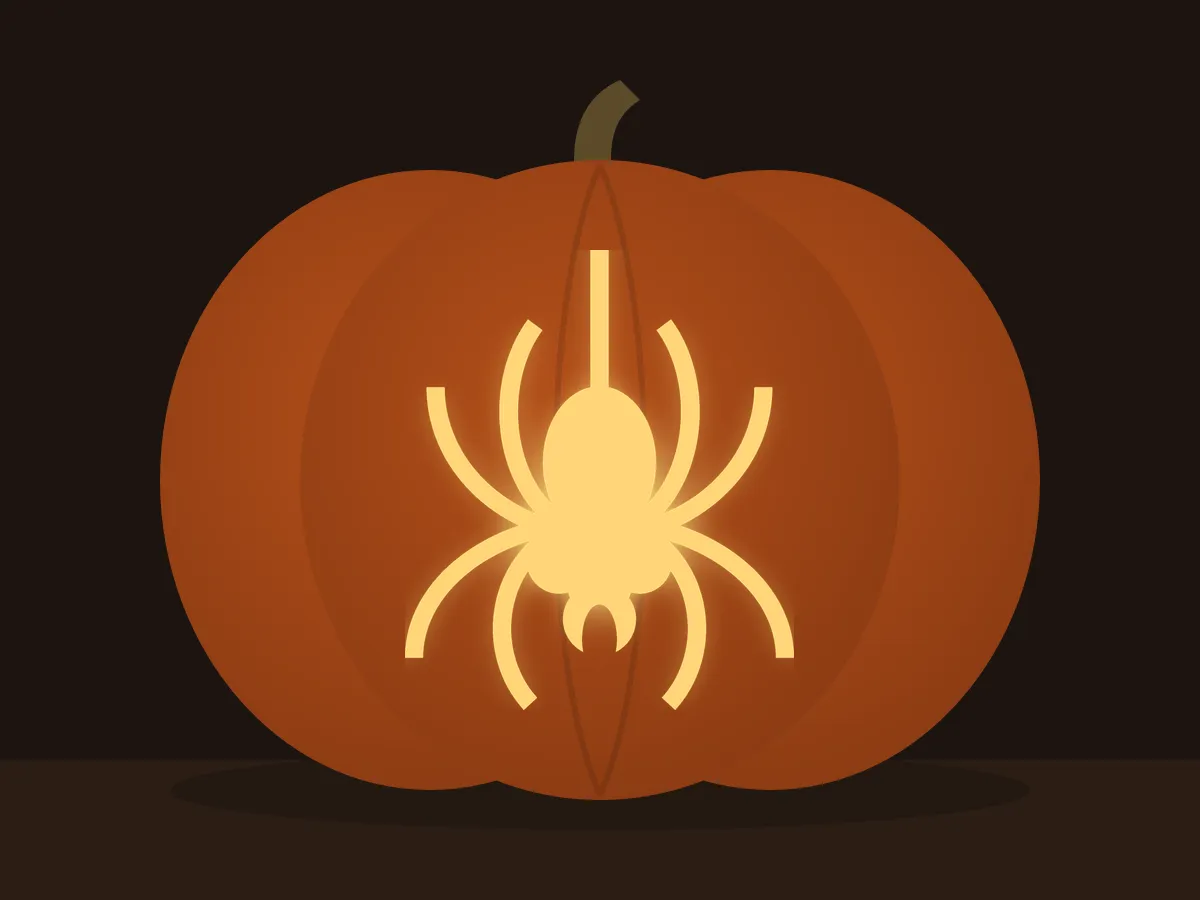 Carved pumpkin with the spider on a thread pattern, lit by a candle