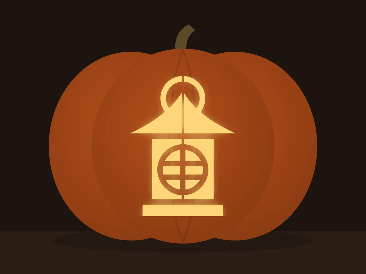Carved pumpkin with the lantern pattern, lit by a candle