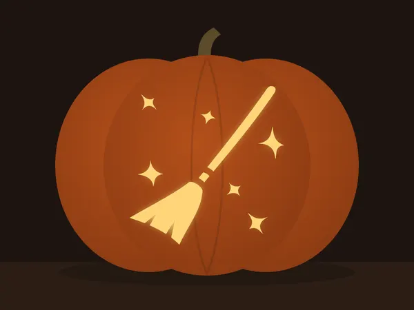 Carved pumpkin with the magic broom pattern, lit by a candle