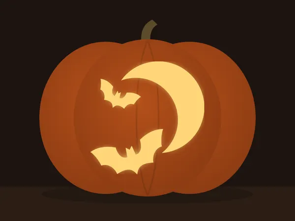 Carved pumpkin with the moon and bats pattern, lit by a candle