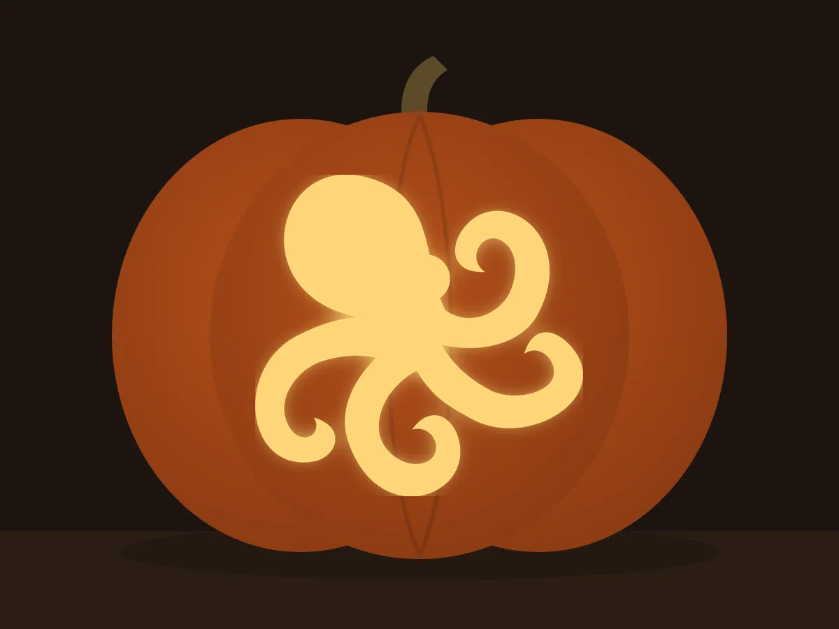 Carved pumpkin with the octopus pattern, lit by a candle