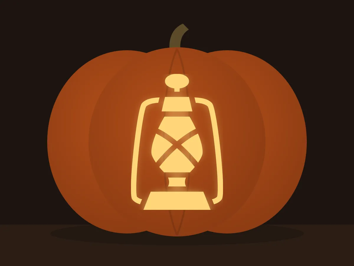 Carved pumpkin with the old lantern pattern, lit by a candle