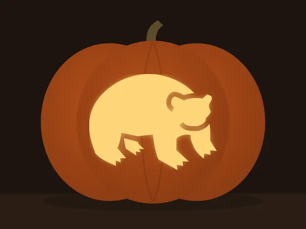 Carved pumpkin with the polar bear pattern, lit by a candle