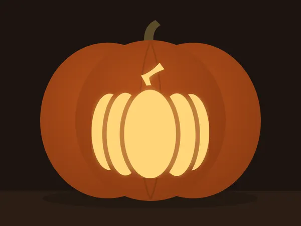 Carved pumpkin with the pumpkin pattern, lit by a candle