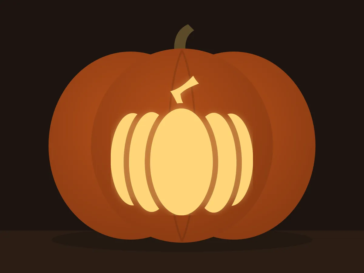 Carved pumpkin with the pumpkin pattern, lit by a candle
