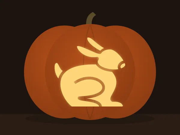 Carved pumpkin with the rabbit pattern, lit by a candle