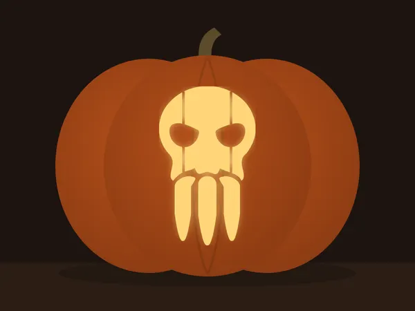 Carved pumpkin with the sabertooth skull pattern, lit by a candle