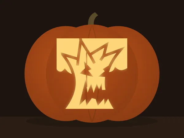 Carved pumpkin with the spooky tree pattern, lit by a candle