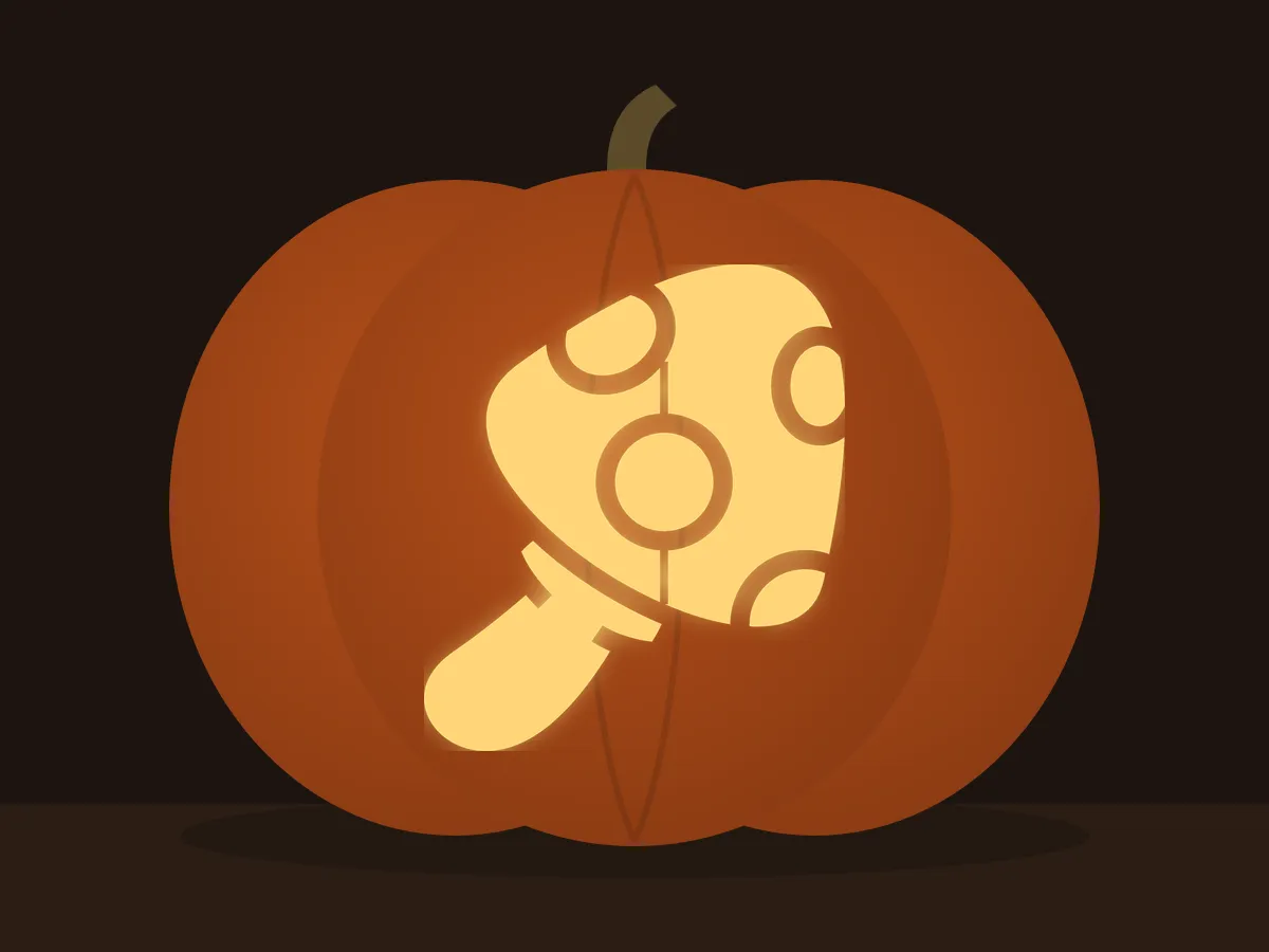 Carved pumpkin with the spotted mushroom pattern, lit by a candle