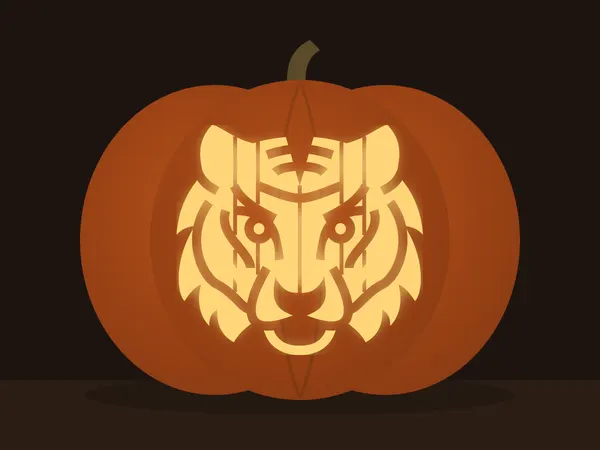 Carved pumpkin with the tiger head pattern, lit by a candle