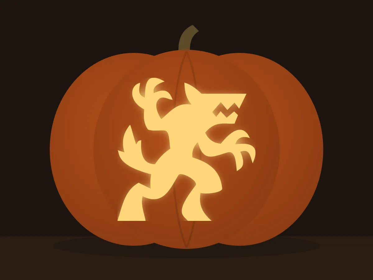 Carved pumpkin with the werewolf pattern, lit by a candle