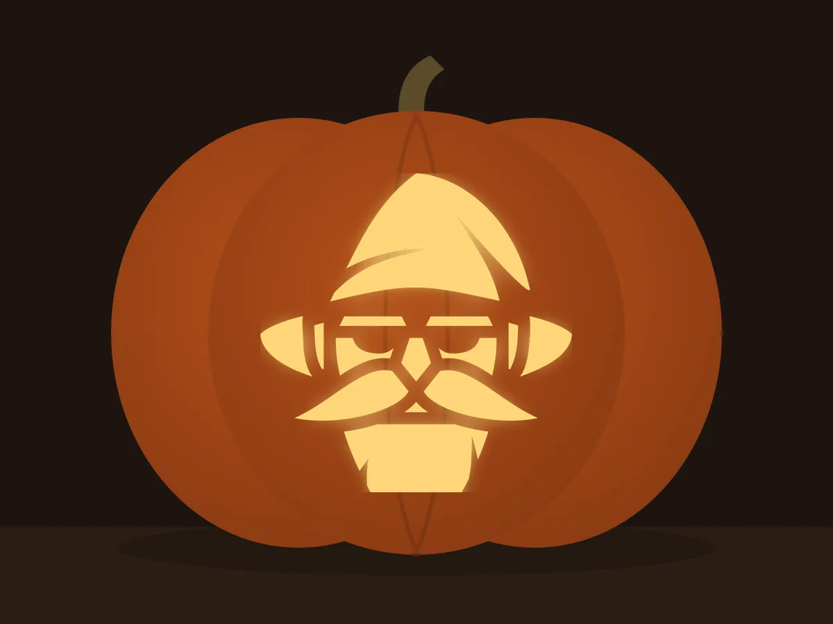 Carved pumpkin with the wizard pattern, lit by a candle